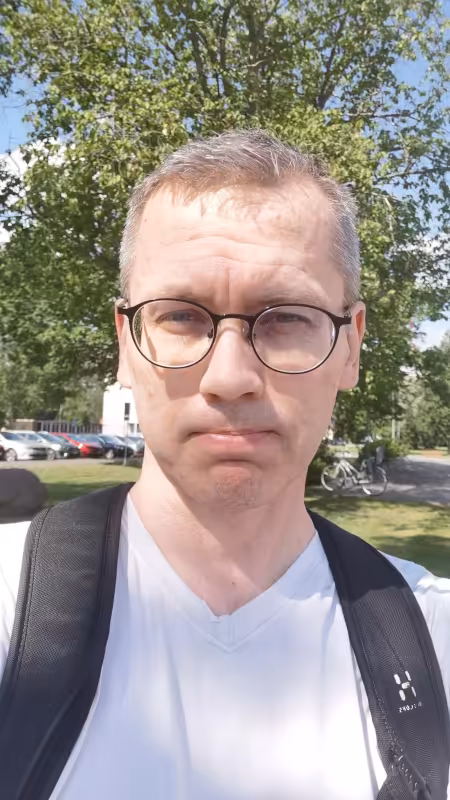 Timo Suonpää in white T-shirt and with backpack.